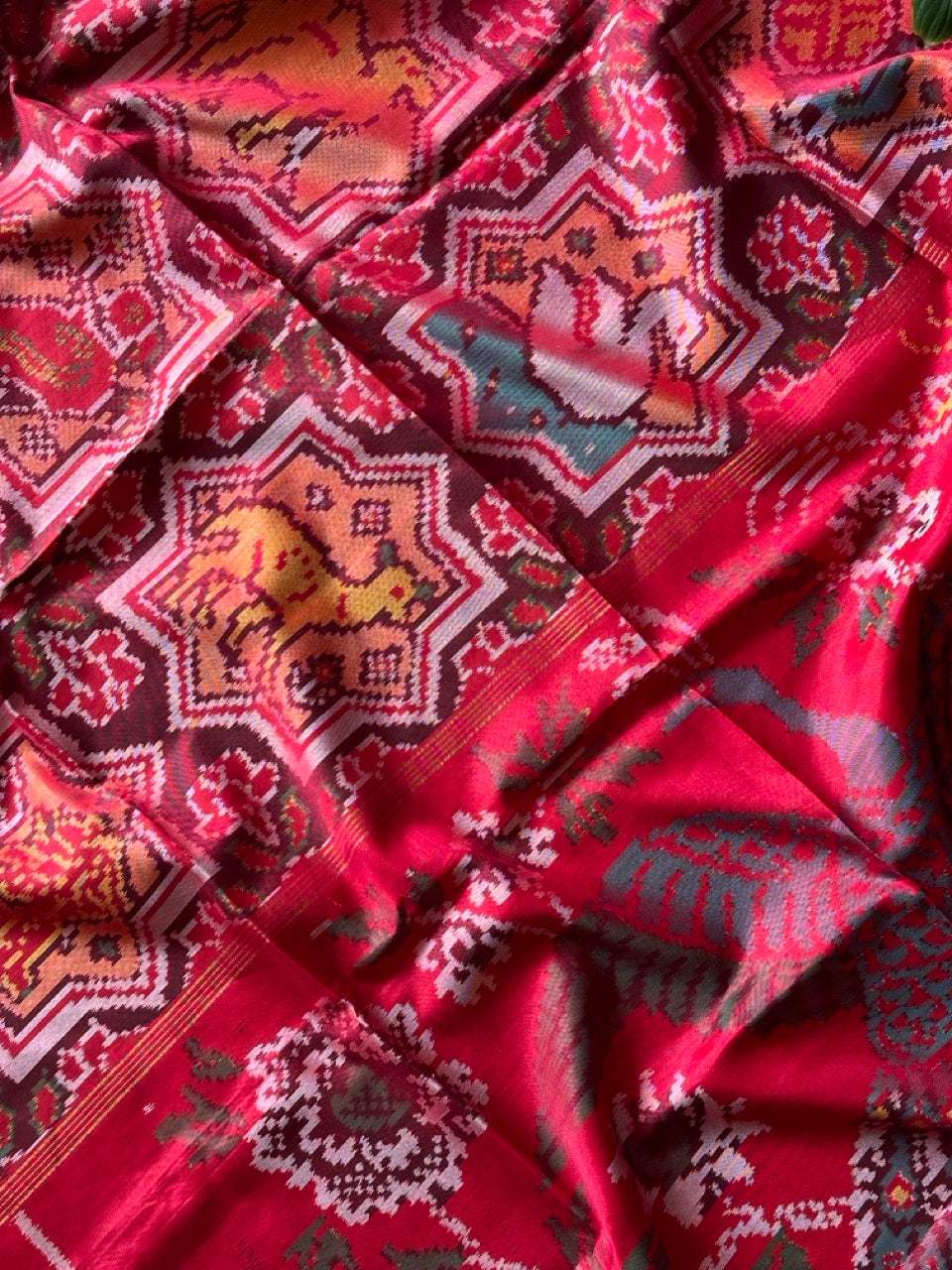 Sophisticated Handloom Brown and Red Mulberry Silk Ikat Patola Saree with Animal Motifs