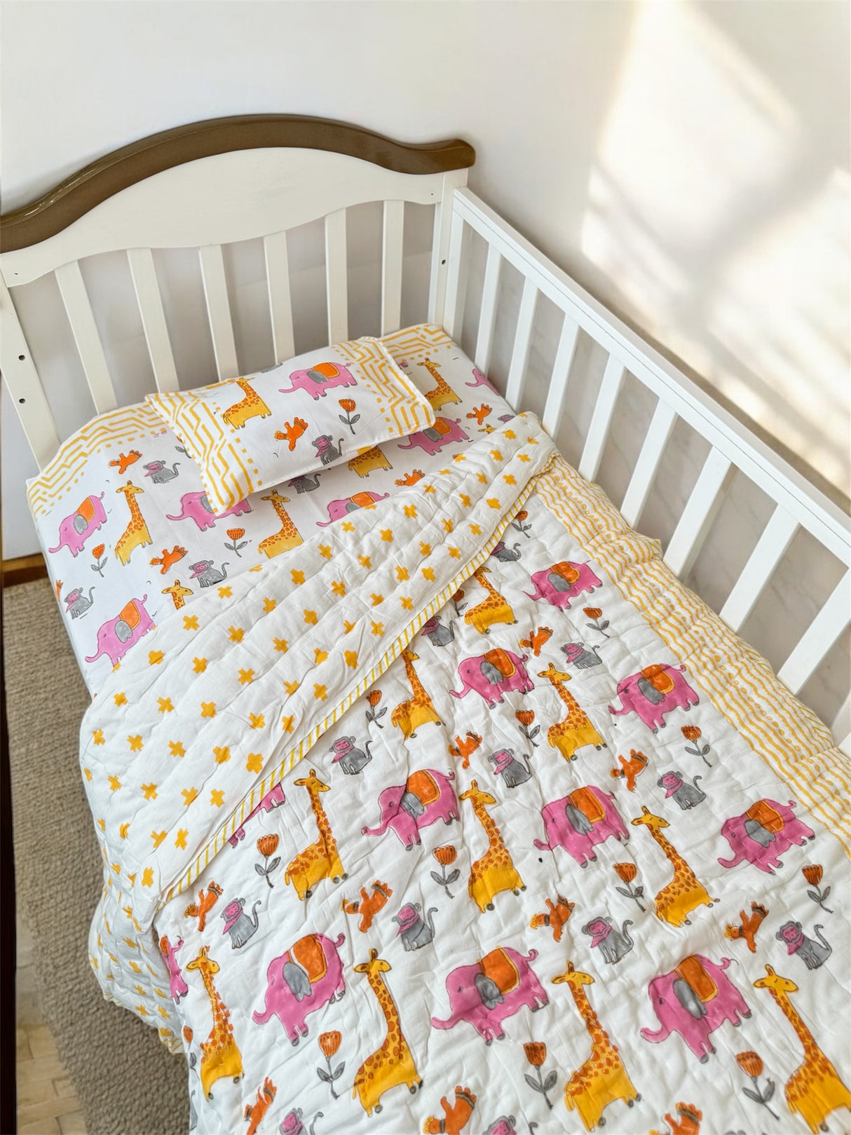 Pink yellow orange cot sheet and quilt for boys room
