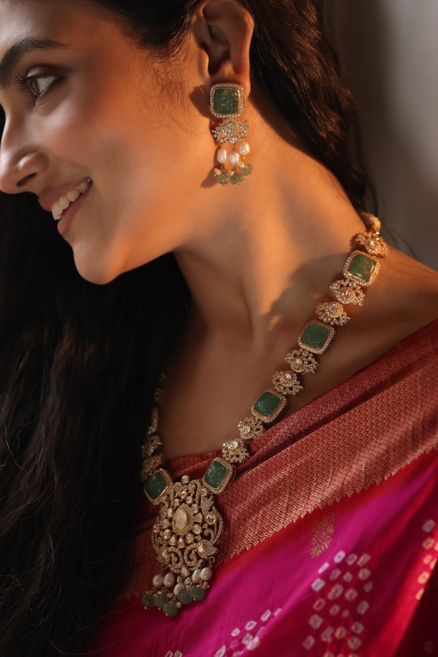 Woman wearing traditional jewelry with a pink saree
