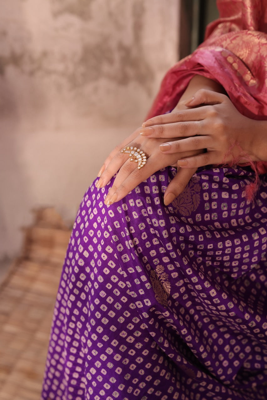 Person wearing a purple patterned garment with a blurred background