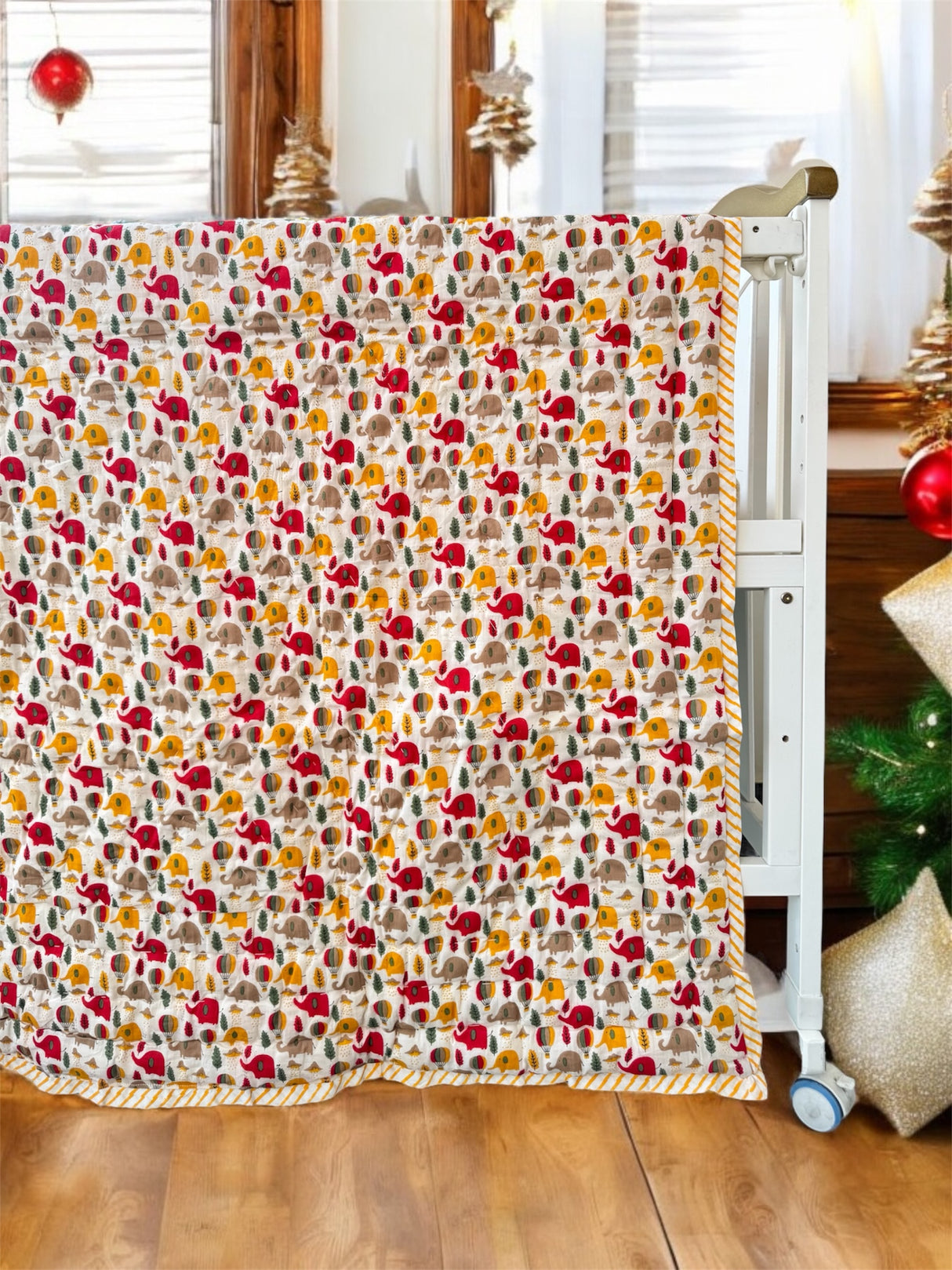 reversible dual print jungle baby quilt with cute elephant jungle family on front and cheerful giraffe friends on reverse made in India for USA and Malaysia