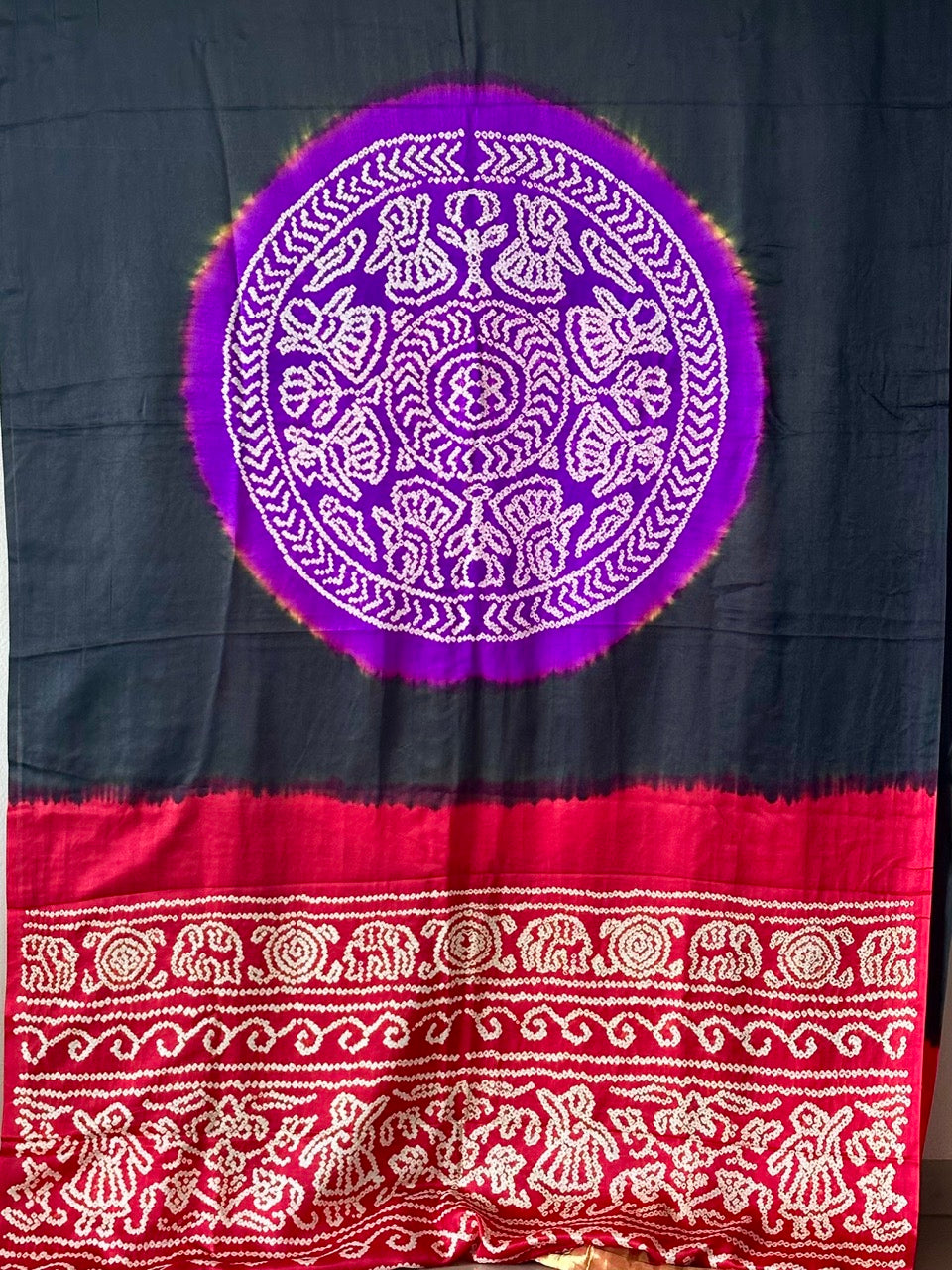 A pure Gajji silk bandhani saree with a black base and multicolored circle theme.