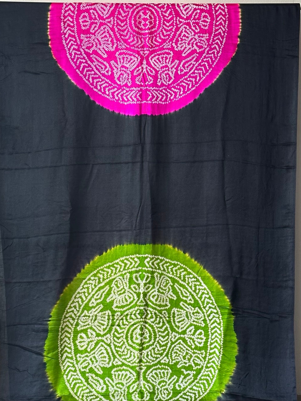 A pure Gajji silk bandhani saree with a black base and multicolored circle theme.