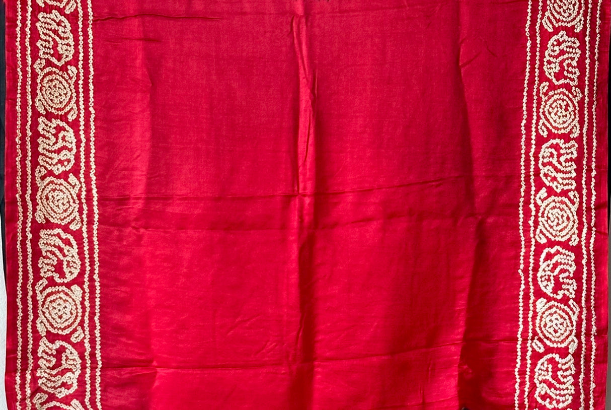 A pure Gajji silk bandhani saree with a black base and multicolored circle theme.