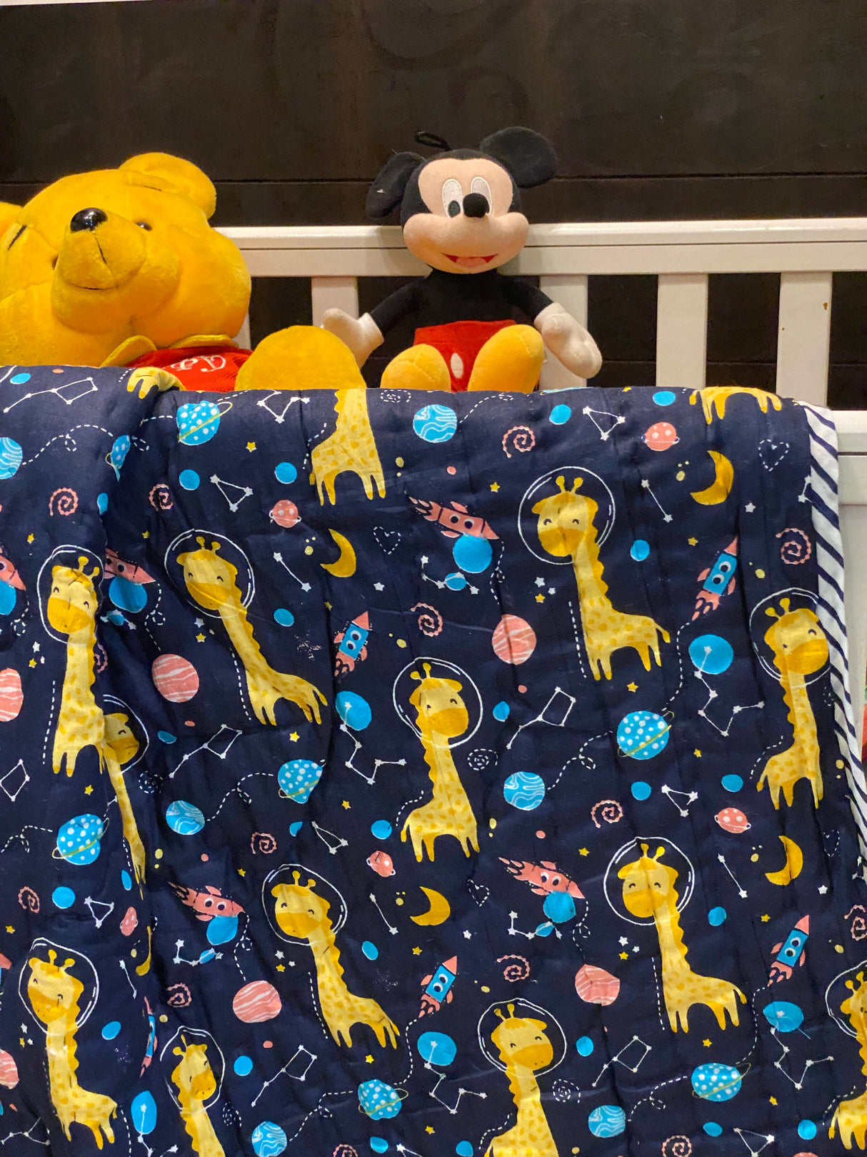 sustainable blue giraffe quilt for toddlers with space sky theme ideal for retail and wholesale orders in UK and Australia