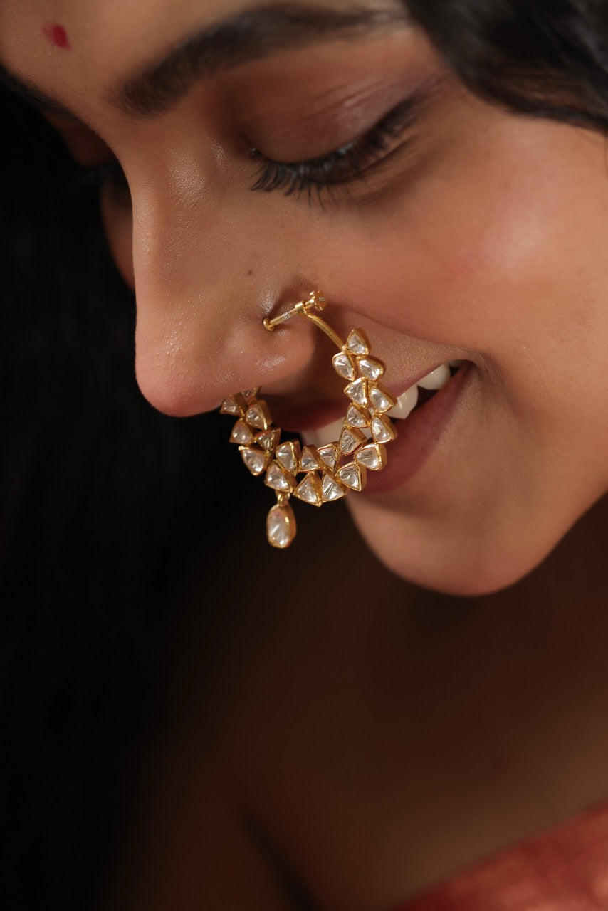 Woman wearing a pink saree with a lovely 92.5 silver nose ring with moissanite polki.