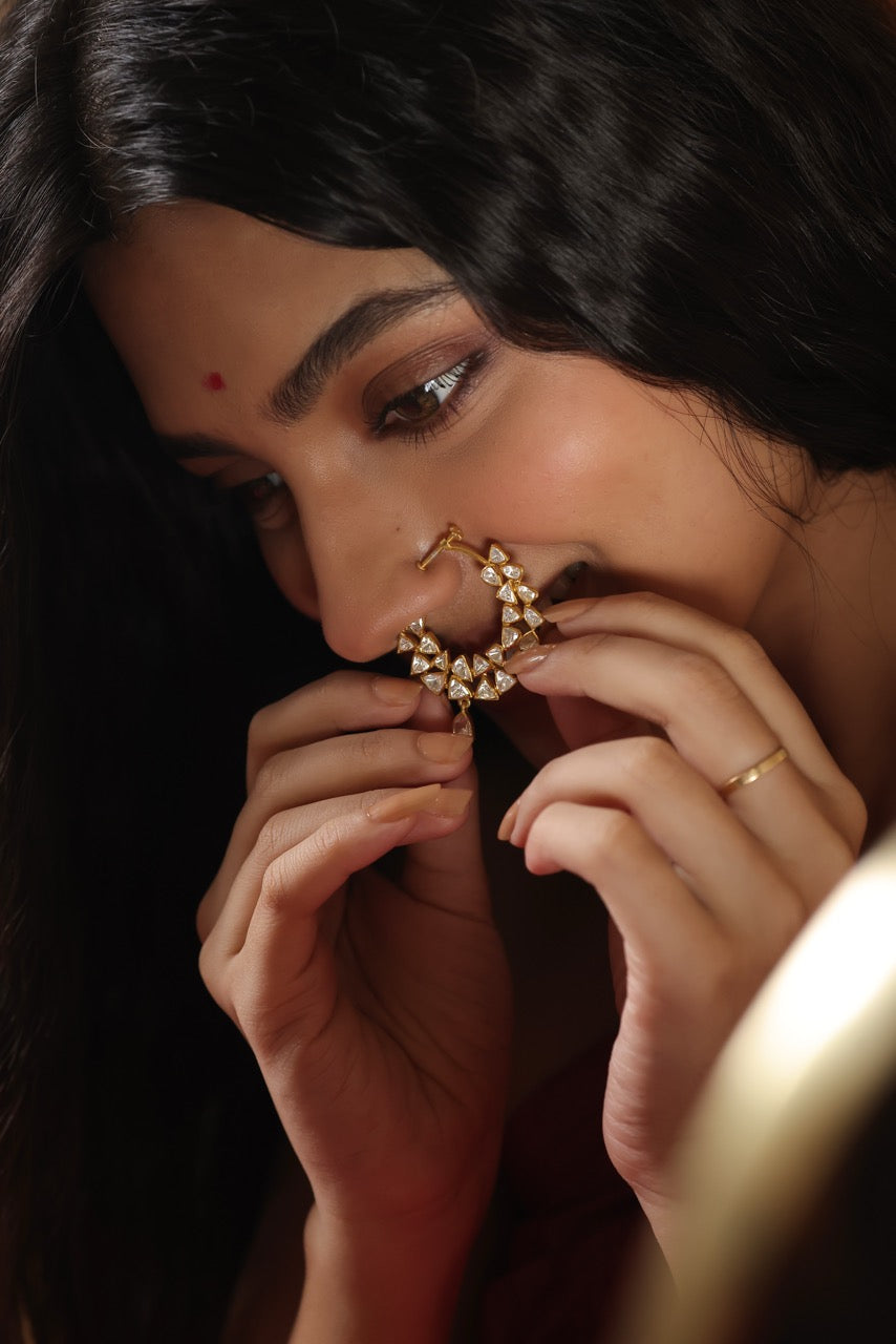 Woman wearing a pink saree with a lovely 92.5 silver nose ring with moissanite polki.