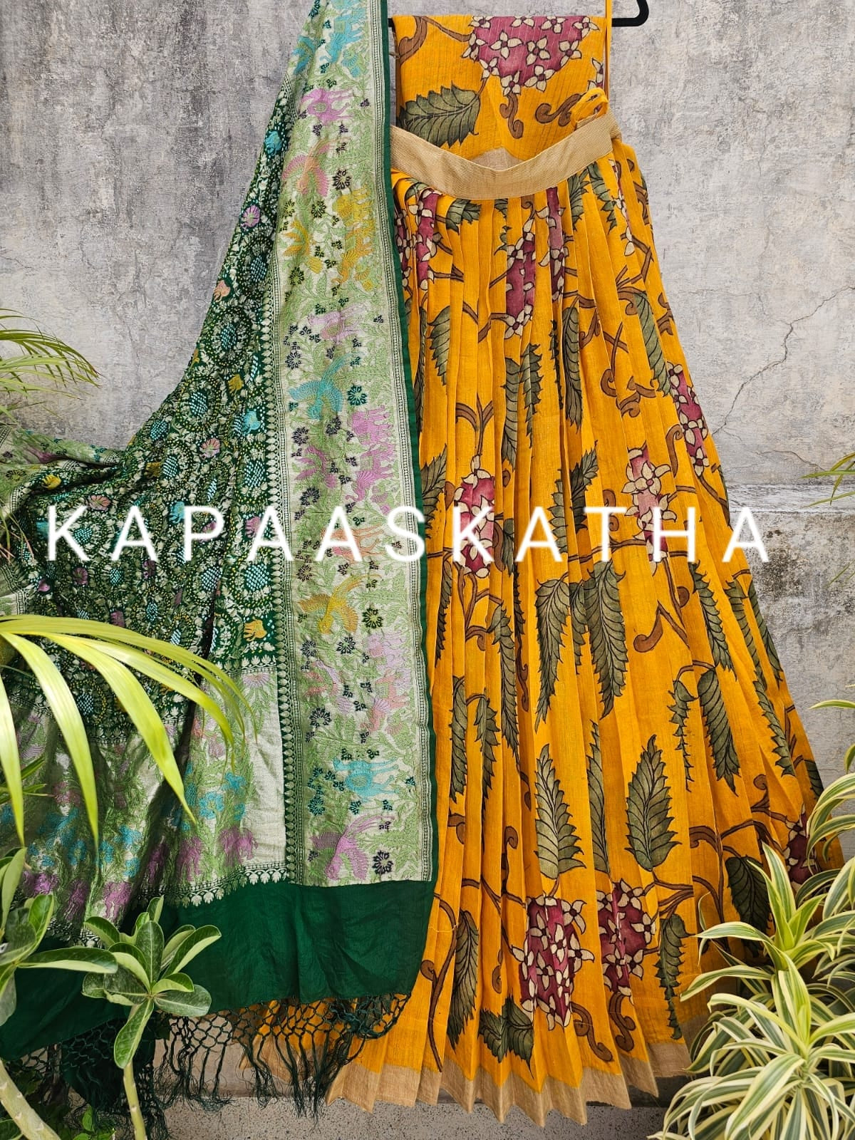 Colorful lehenga with floral patterns featuring the brand 'Kapaaskatha'.