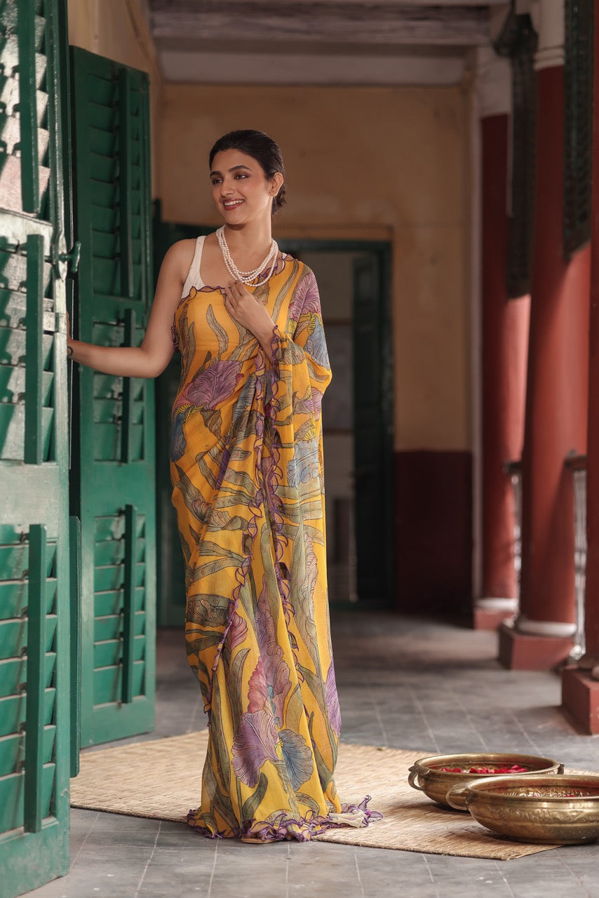 Woman in a colorful saree standing in a traditional setting with green shutters and gold pots.