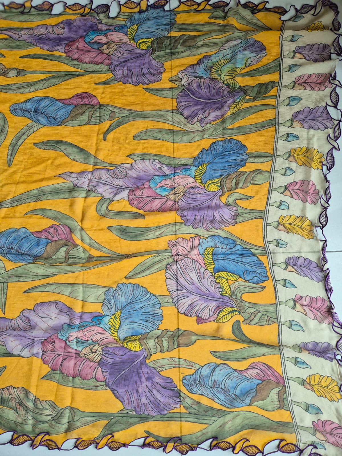 Colorful floral pattern on a yellow kalamkari saree