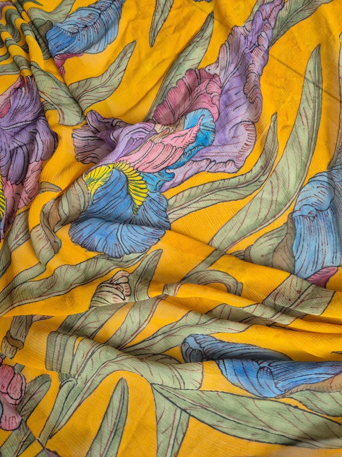 Colorful floral pattern on a yellow kalamkari saree
