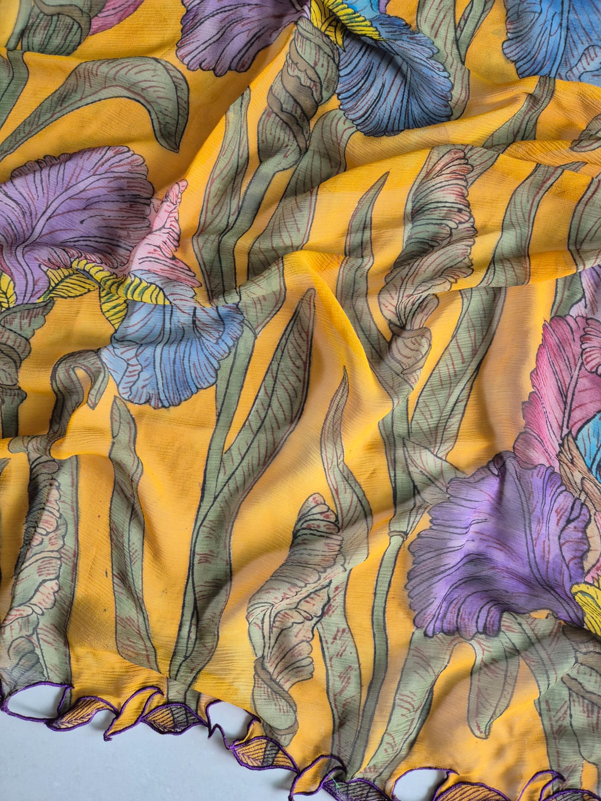 Colorful floral pattern on a yellow kalamkari saree