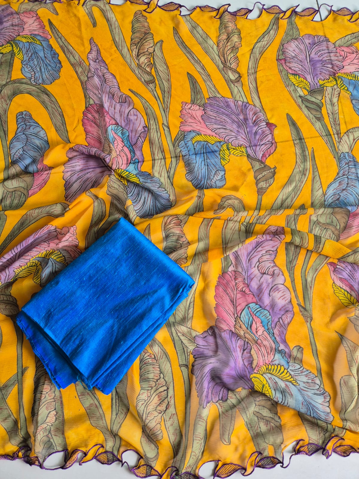 Blue fabric on a yellow fabric with floral pattern