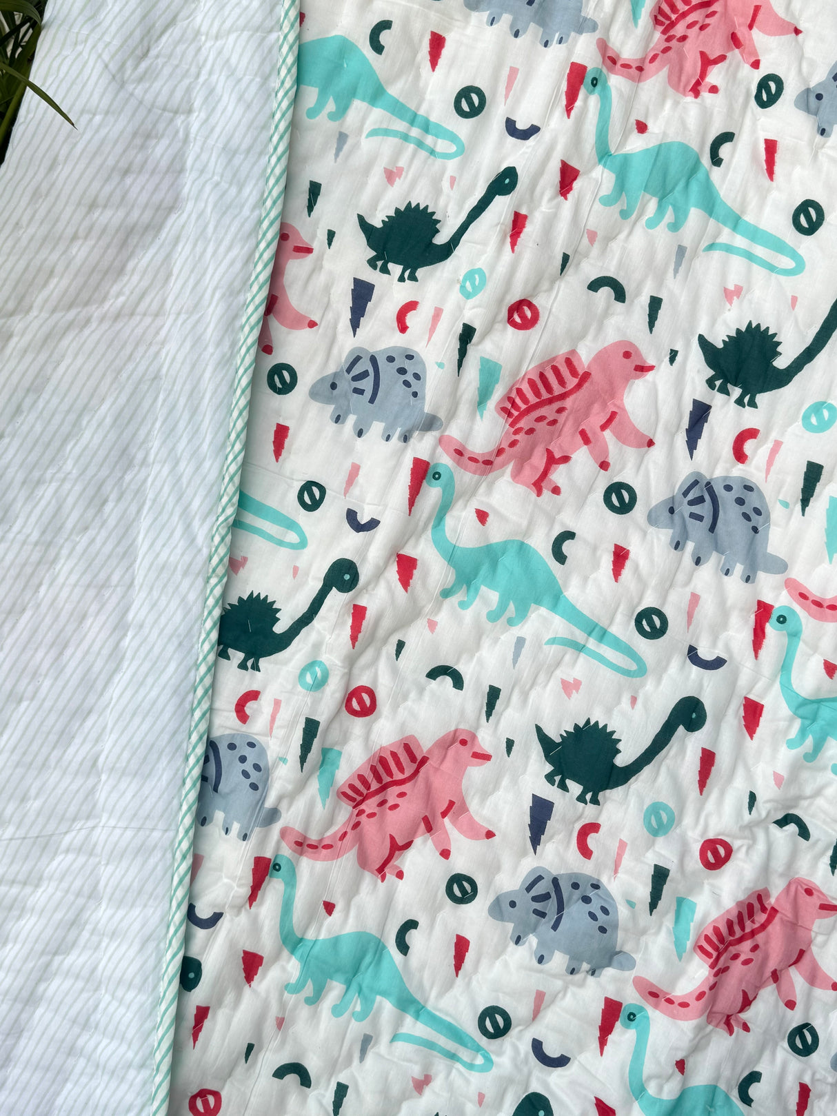 artisan made cotton dohar with turquoise dinosaur design for modern nursery gifting in UK and Germany