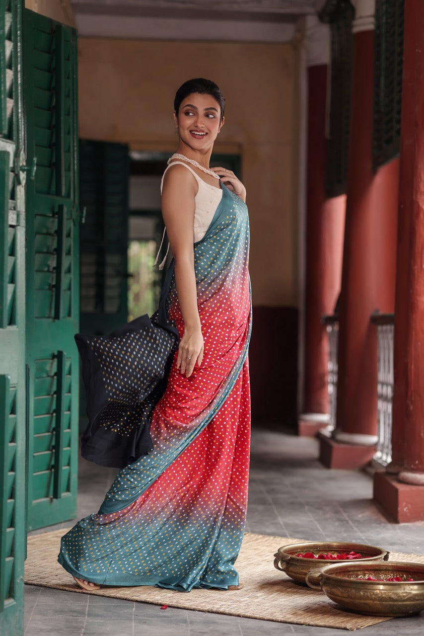 Woman in a colorful saree standing in a traditional setting
