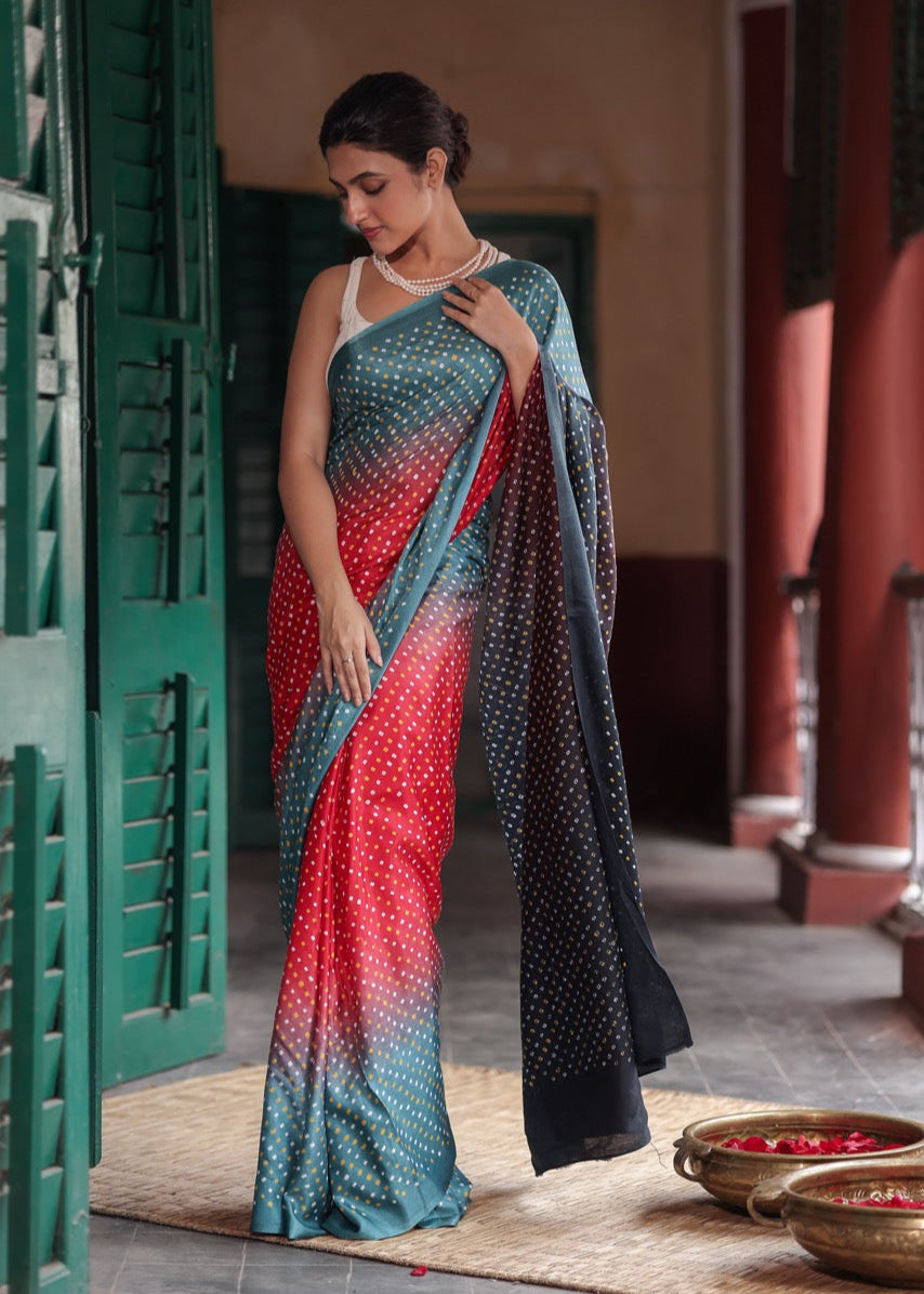Woman in a colorful saree standing in a traditional setting