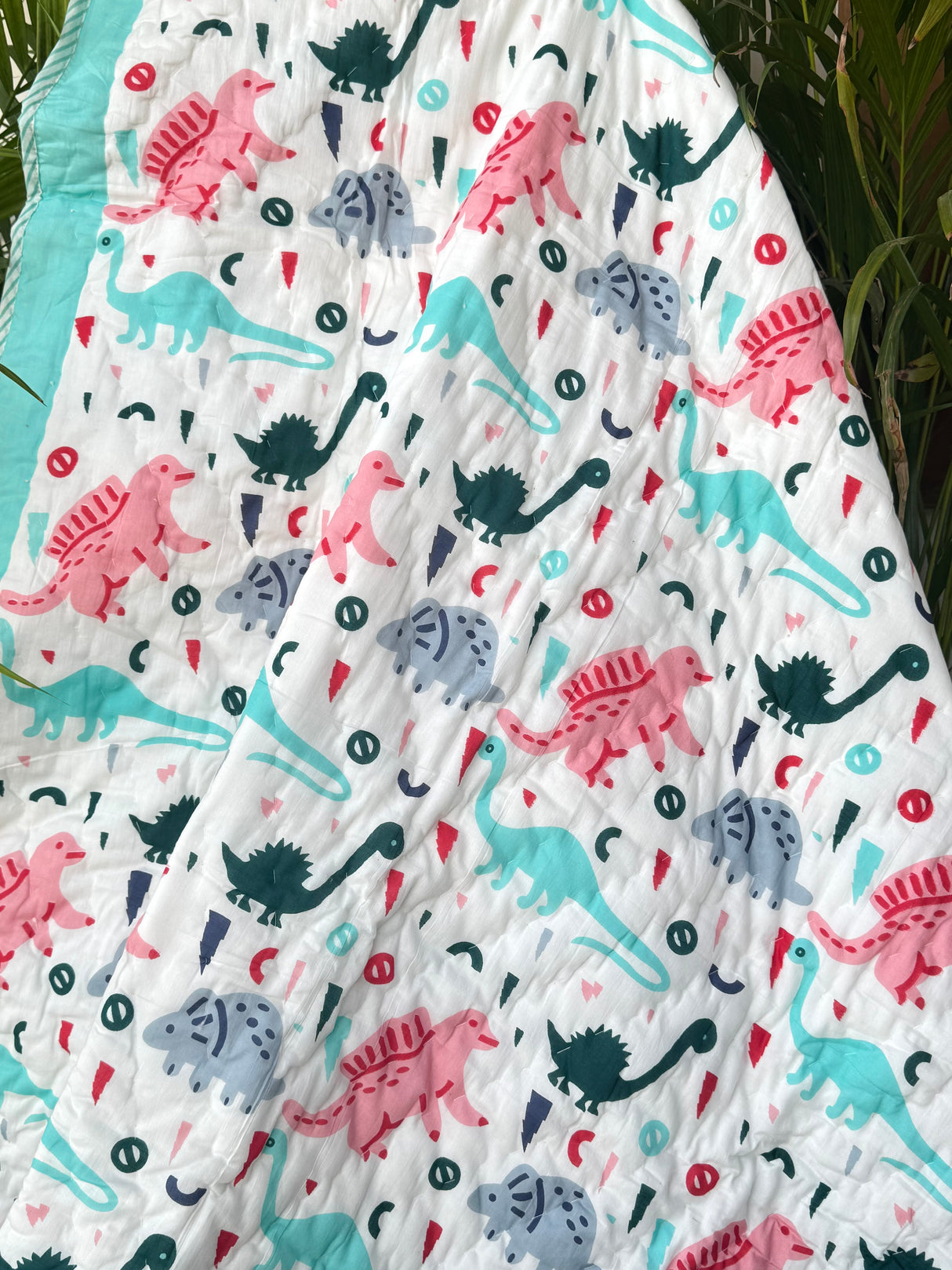 bright turquoise dinosaur quilt for toddlers in soft cotton perfect for wholesale gifting in Singapore and South Africa