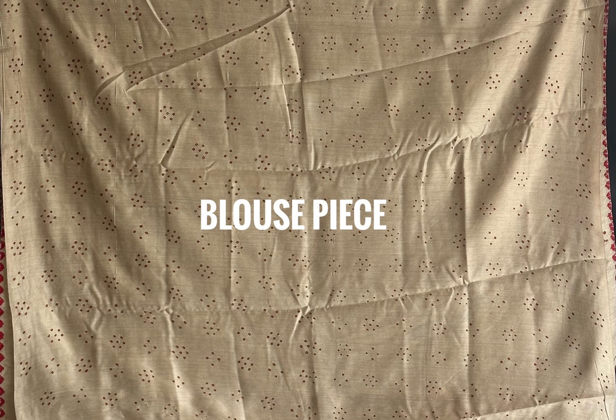 Buy pure Munga silk Bandhani saree in linen beige with soft red ghangura border. Lightweight handloom elegance for daytime festivities at Kapaas Katha.