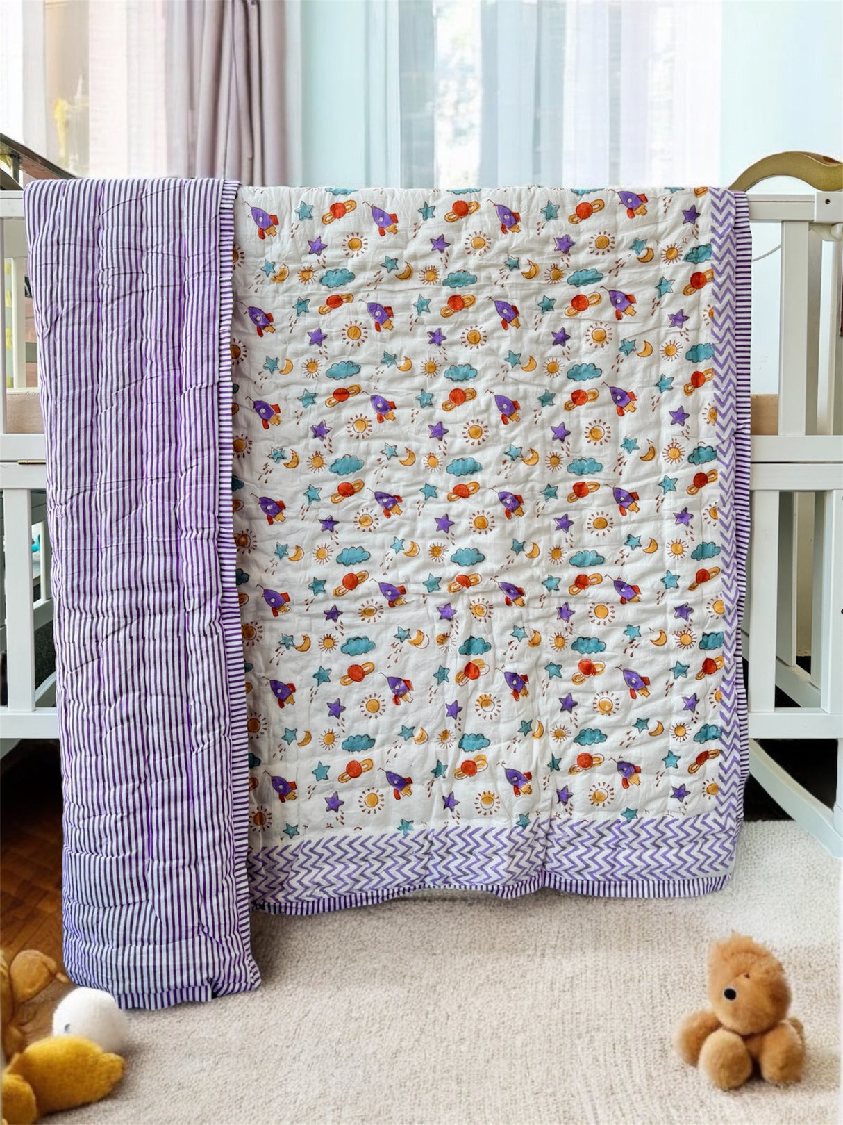 breathable cotton kids quilt in purple galaxy theme with stars and planets handmade by Jaipur artisans for bulk orders in UK and Australia