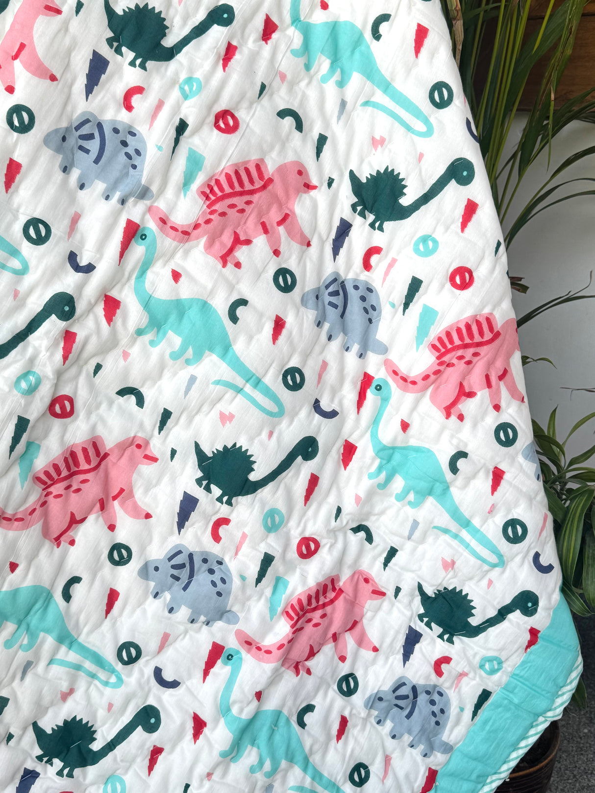 lightweight cotton dinosaur baby dohar in soothing turquoise ideal for gifting in Germany and New Zealand