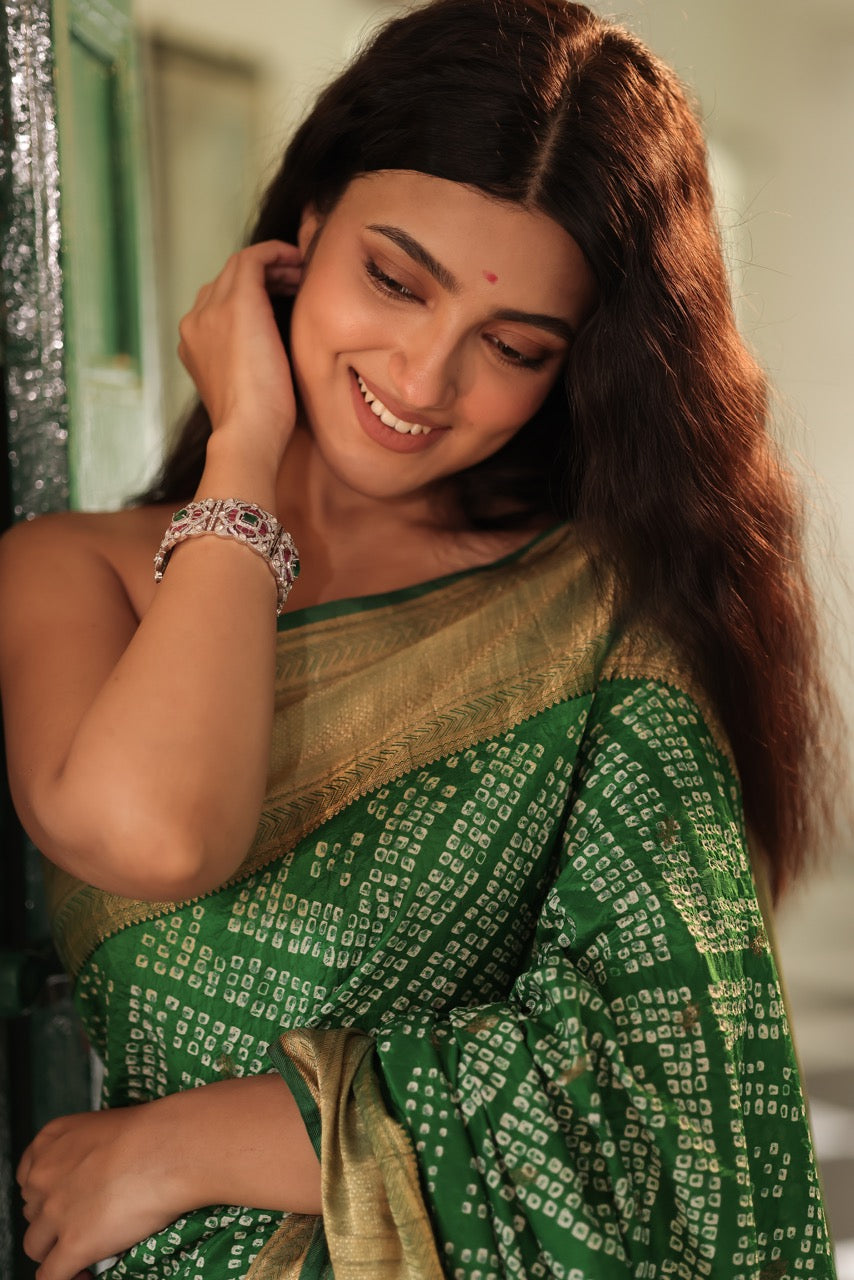 Woman wearing a green saree with a 92.silver kada