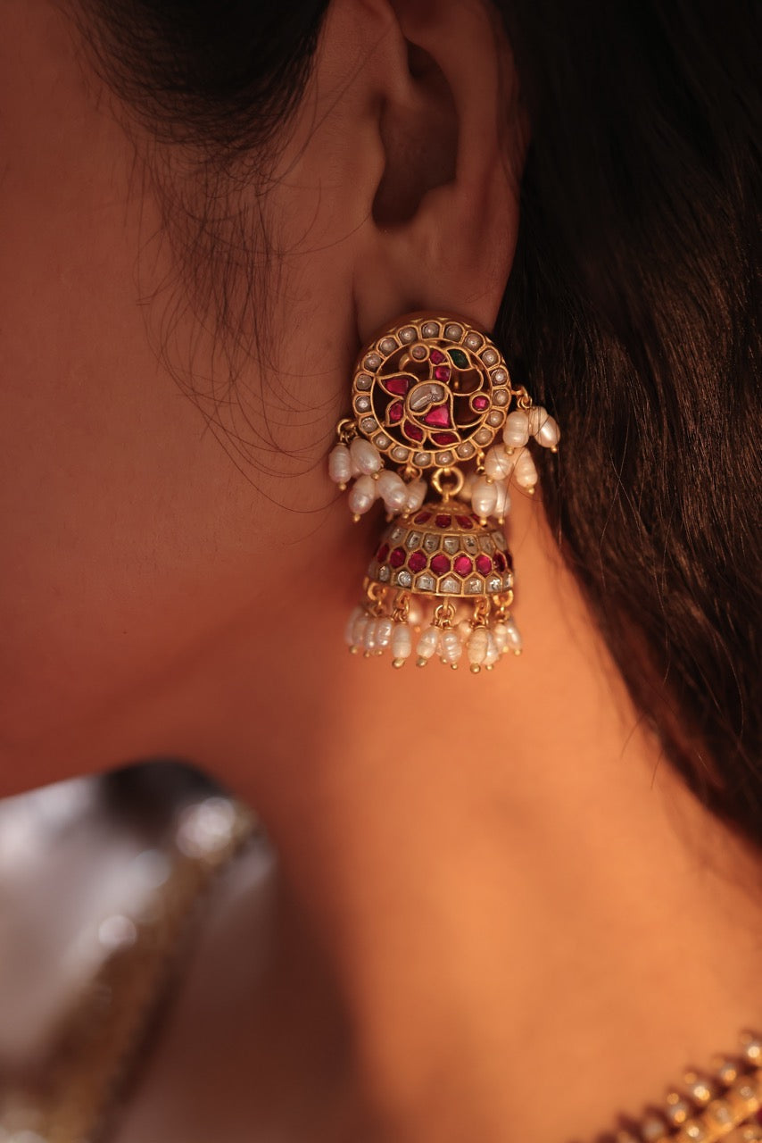 Woman wearing a traditional red saree with 92.5 silver jewelry called guttapusalu with lovely jhumkis
