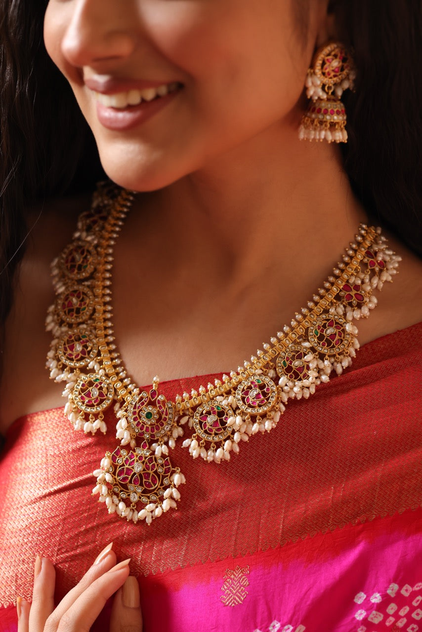 Woman wearing a traditional red saree with 92.5 silver jewelry called guttapusalu with lovely jhumkis