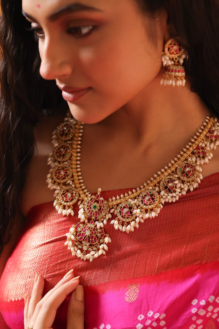 Woman wearing a traditional red saree with 92.5 silver jewelry called guttapusalu with lovely jhumkis