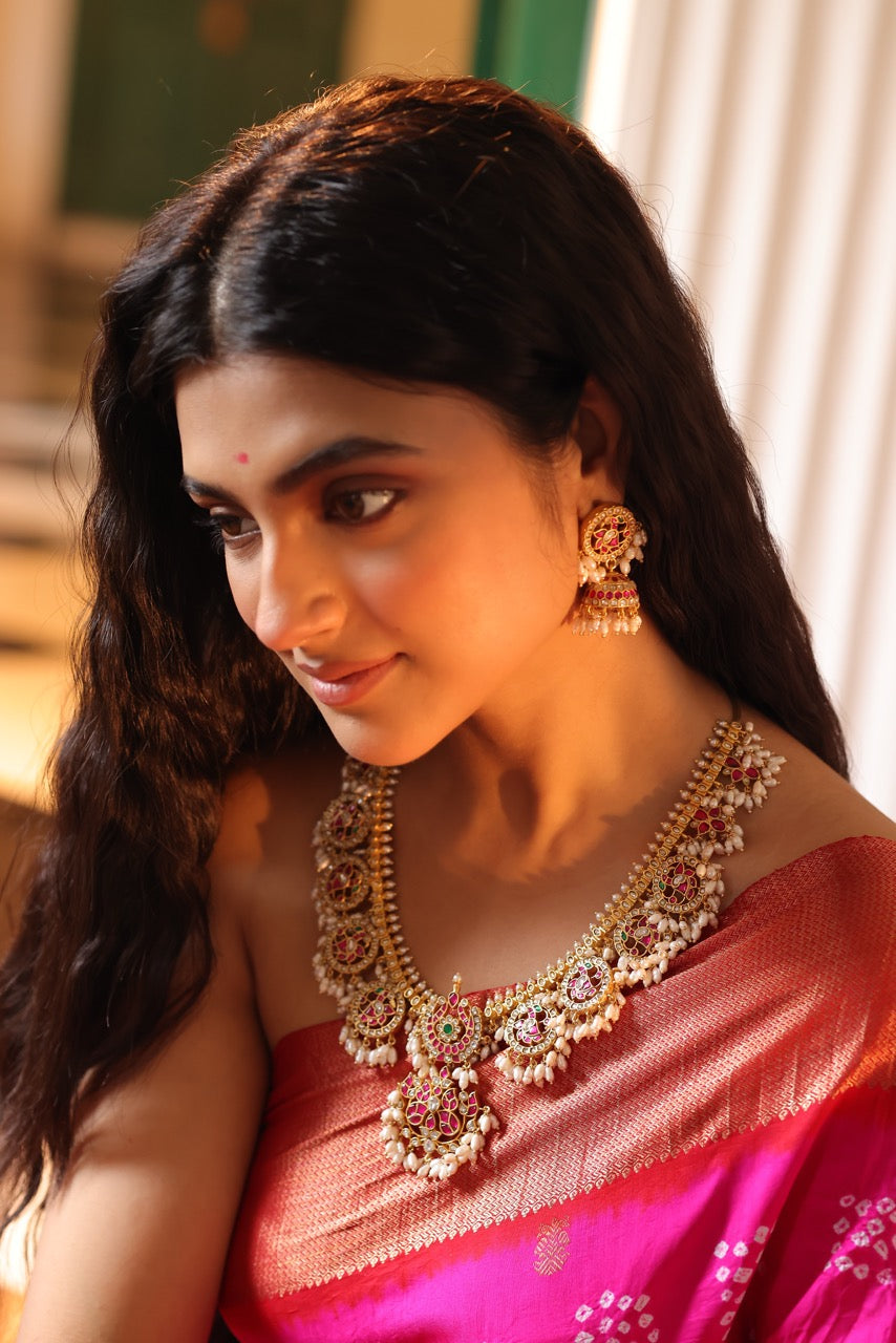 Woman wearing a traditional red saree with 92.5 silver jewelry called guttapusalu with lovely jhumkis