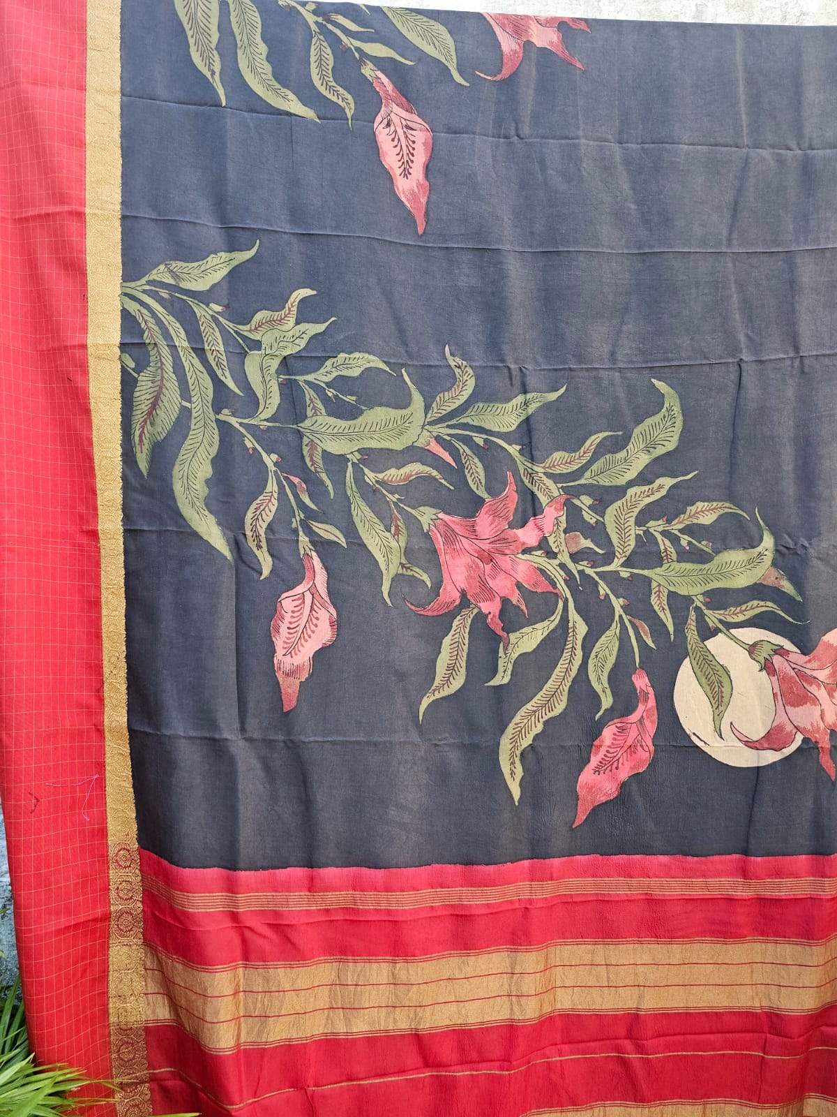 red-border-floral-kanjivaram-kalamkari-saree-hanging-display