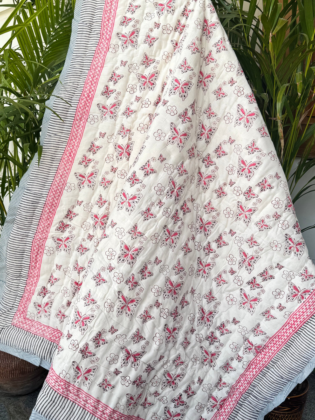 pink-butterfly-themed-kids-quilt-with-contrasting-yellow-blue-print-on-reverse-for-retail-in-canada