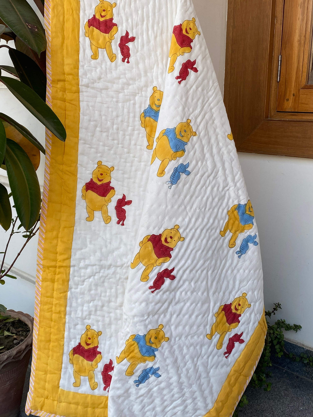 reversible-mulmul-baby-quilt-with-cute-red-pooh-design-perfect-for-bulk-gifting-in-australia-and-dubai