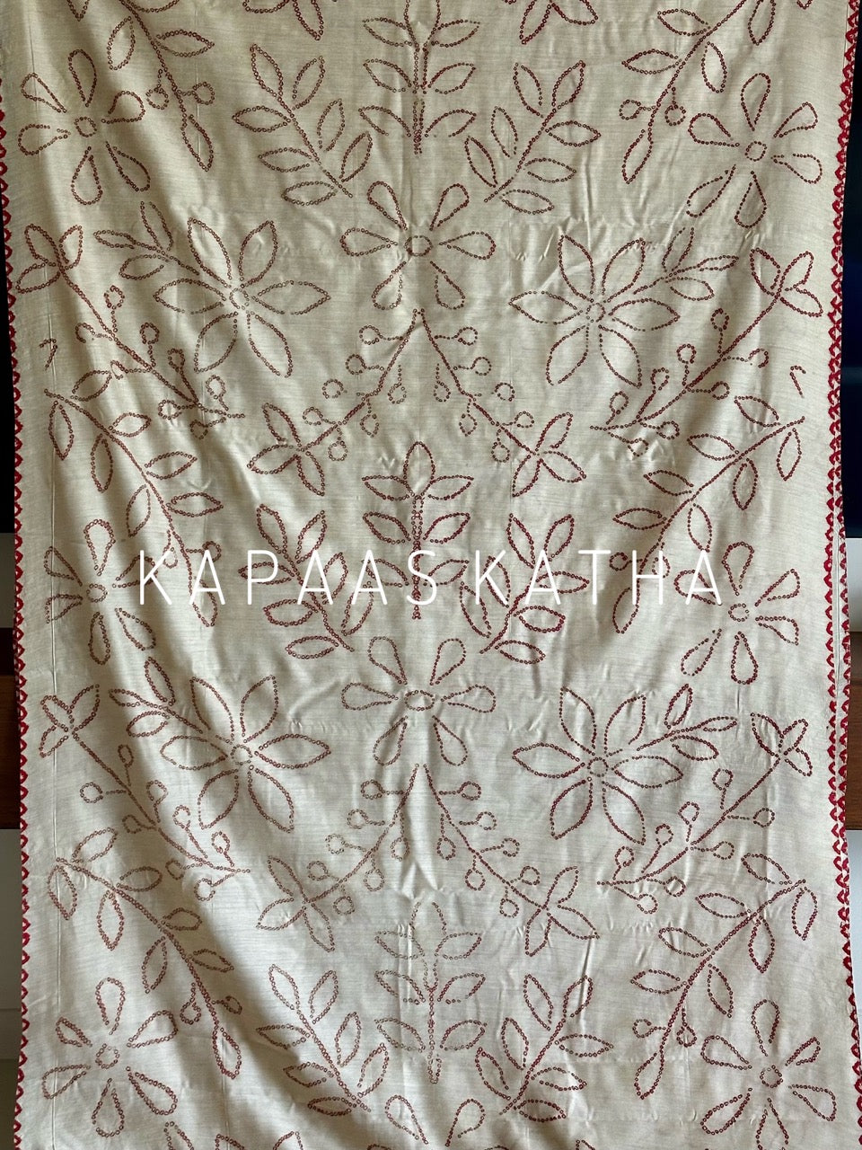 Buy pure Munga silk Bandhani saree in linen beige with soft red ghangura border. Lightweight handloom elegance for daytime festivities at Kapaas Katha.