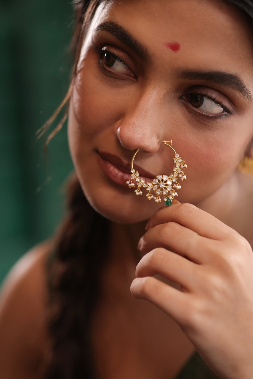 Woman in a green saree wearing 92.5 silver nath with moissanite polki