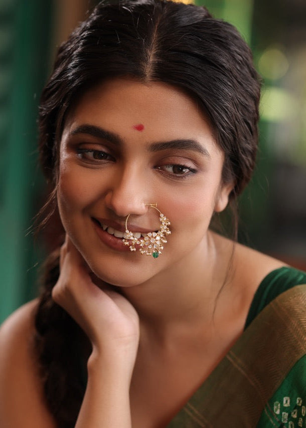 Woman in a green saree wearing 92.5 silver nath with moissanite polki