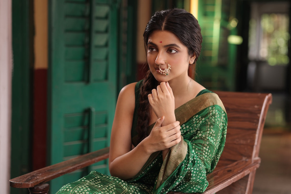 Woman in a green saree wearing 92.5 silver nath with moissanite polki