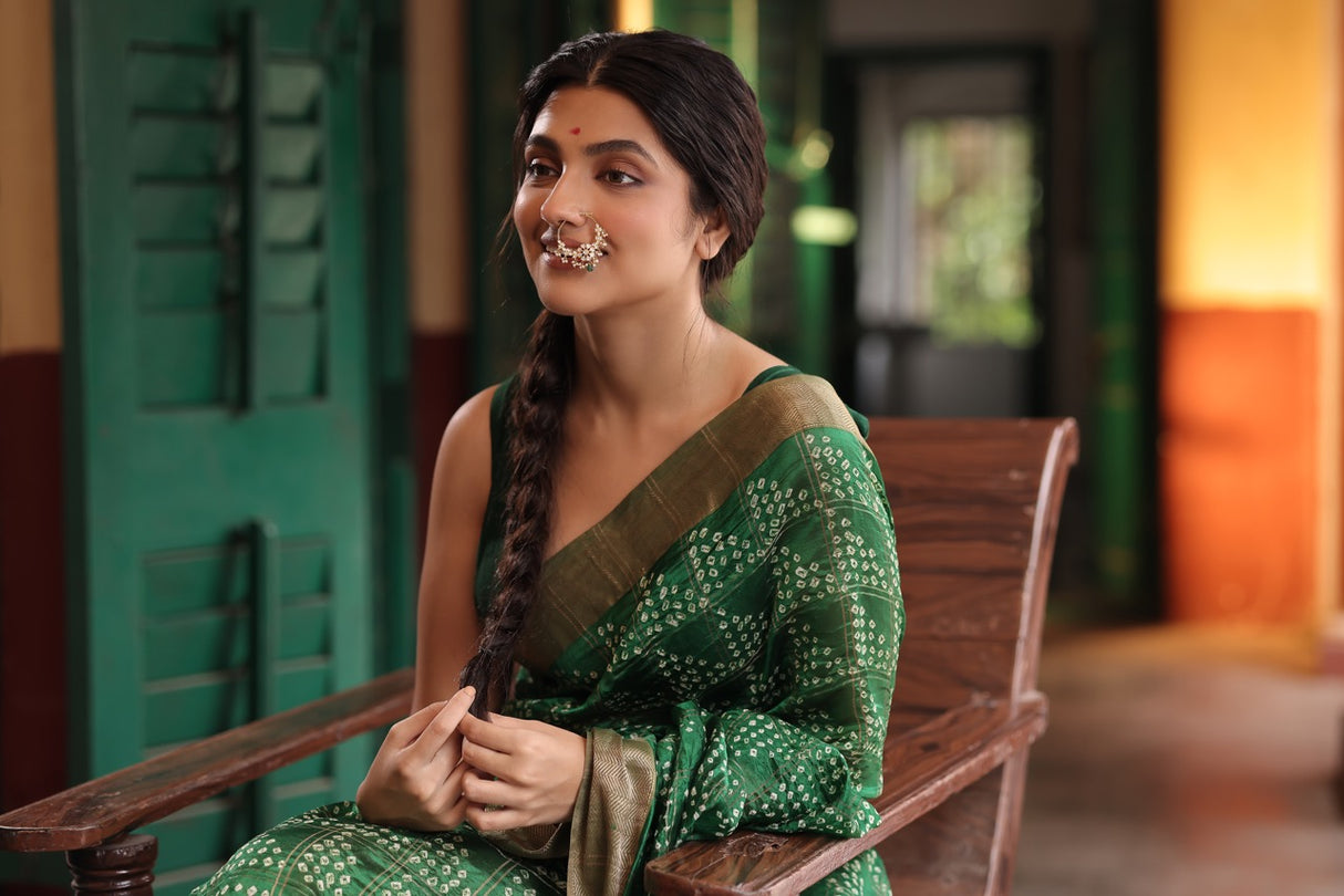 Woman in a green saree wearing 92.5 silver nath with moissanite polki