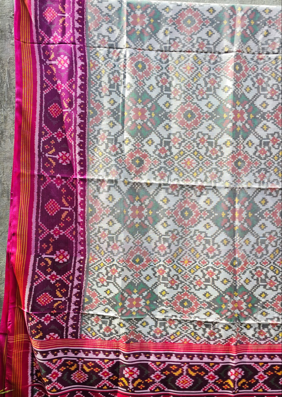 Timeless Handloom White and Pink Mulberry Silk Ikat Patola Saree with Intricate Navratna Motif