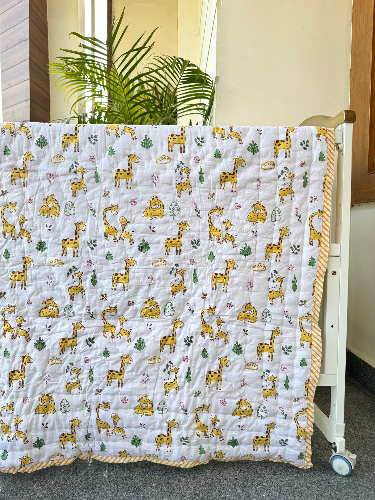 handblock giraffe themed cotton quilt in pastel yellow perfect for birthday return gifts in Saudi Arabia and UK