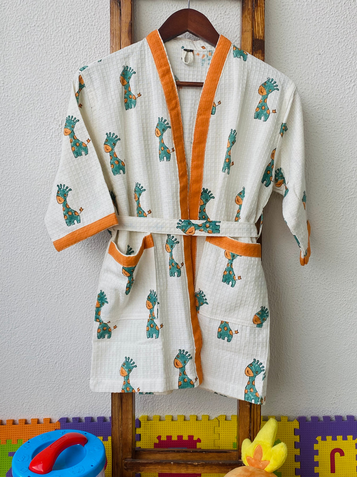 soft waffle cotton kids bathrobe with embroidered name and handblock giraffe prints ideal for boutique resellers in South Korea and Spain