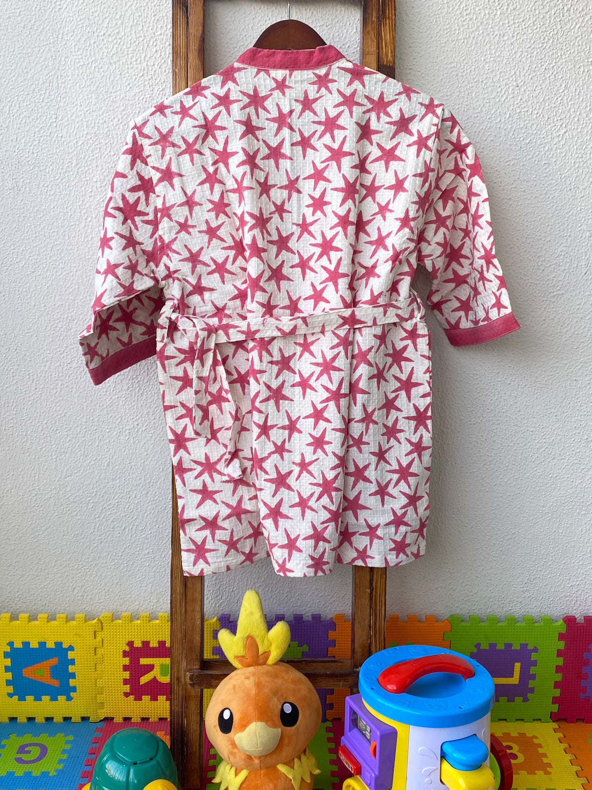 pink star print bathrobe in waffle cotton for girls custom embroidered with child’s name ideal for boutiques and party gifting