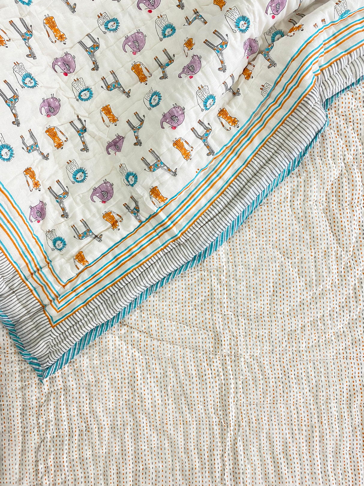 adorable nursery print quilt for toddlers with jungle animals made in India by skilled artisans for global wholesale