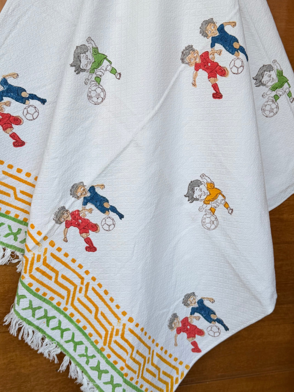 football-players-print-towel-fringed-border-detail