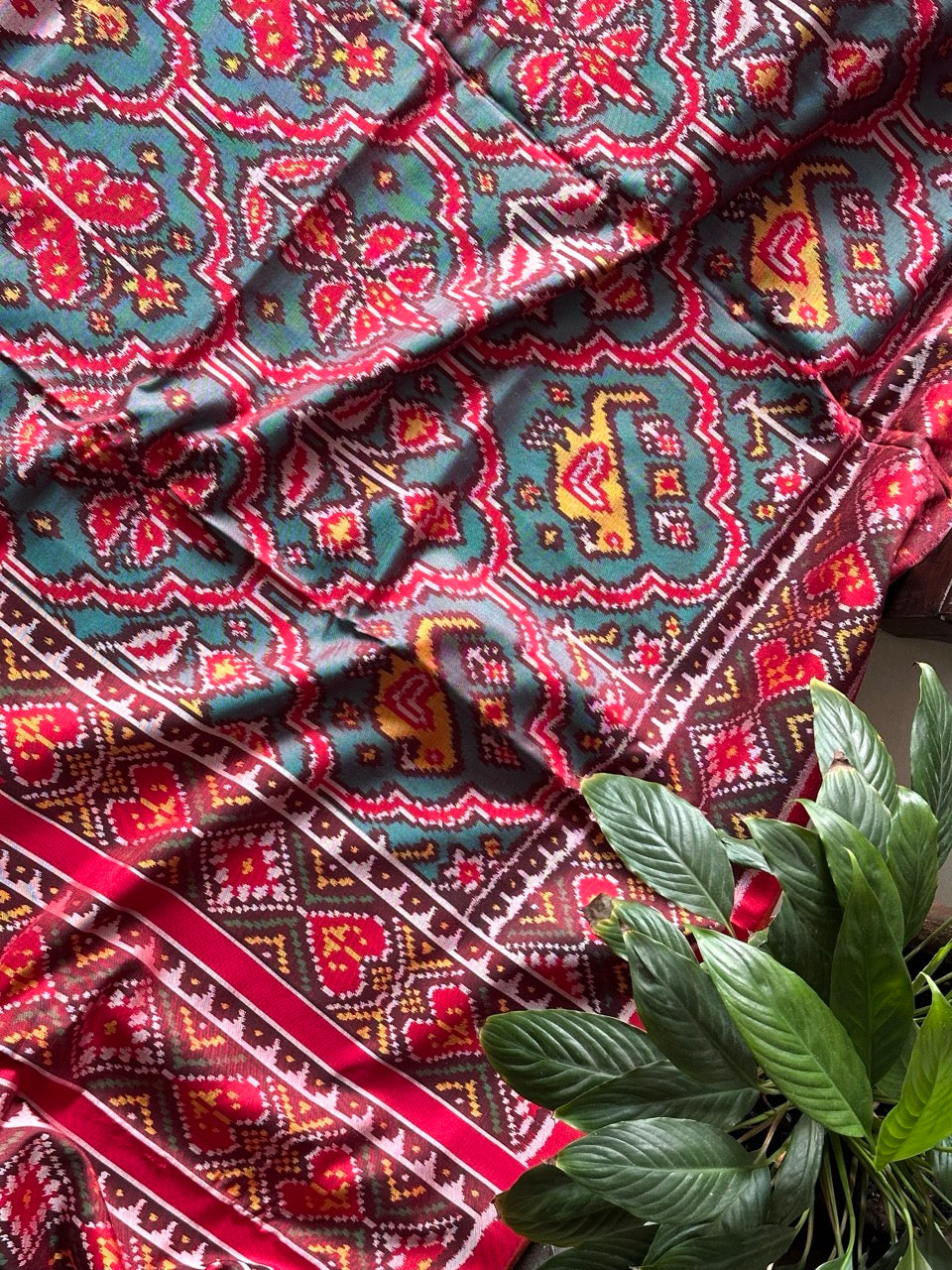 Distinct Handloom Teal and Red Mulberry Silk Ikat Patola Saree with Flora and Fauna