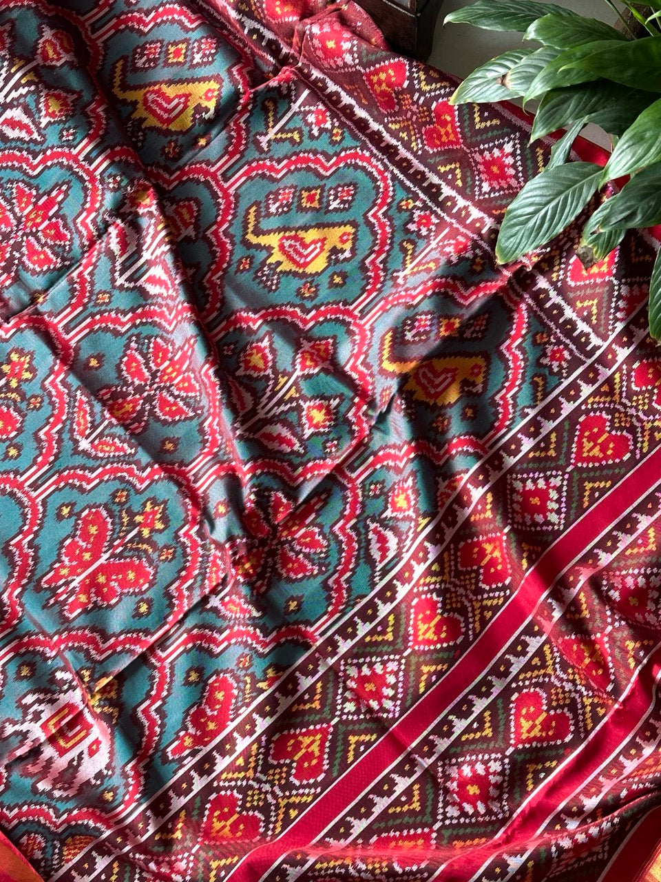 Distinct Handloom Teal and Red Mulberry Silk Ikat Patola Saree with Flora and Fauna