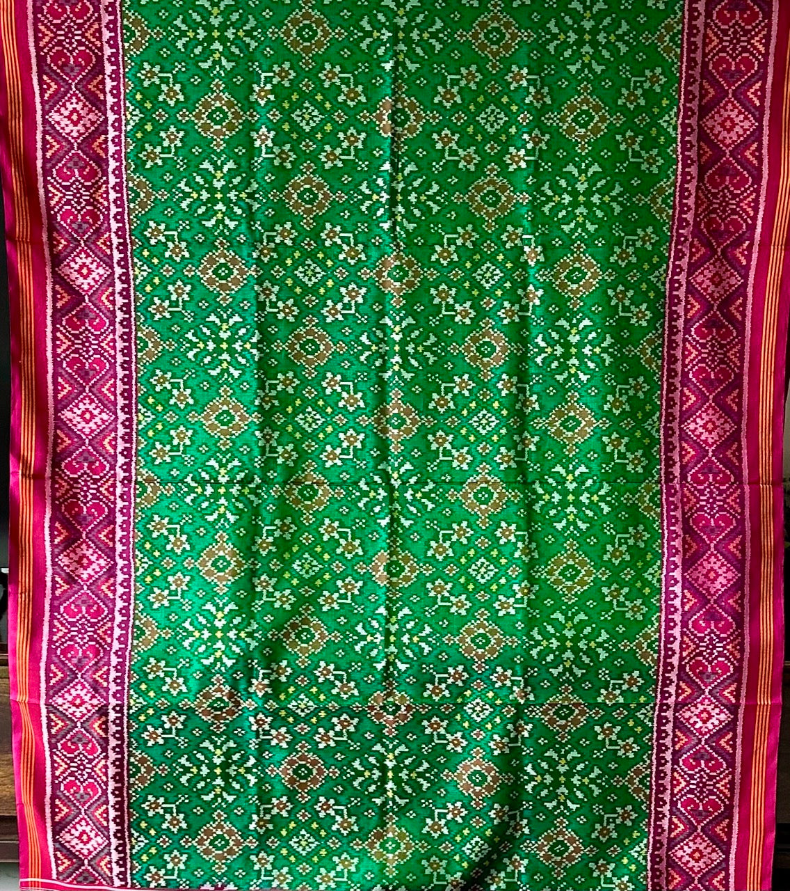 Timeless Handloom Green and Pink Mulberry Silk Ikat Patola Saree with Intricate Navratna Motif