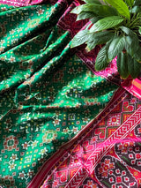 Timeless Handloom Green and Pink Mulberry Silk Ikat Patola Saree with Intricate Navratna Motif