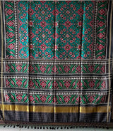 Stylish Handloom Teal and Black Mulberry Silk Ikat Patola Saree with Intricate Navratna Motif