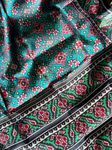 Stylish Handloom Teal and Black Mulberry Silk Ikat Patola Saree with Intricate Navratna Motif