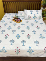 Palm tree print bedsheet styled on a bed